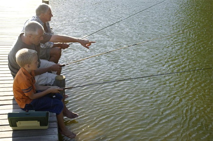 Boy, Father, and Grandfather Fishing from Dock