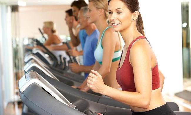 Woman On Running Machine In Gym
