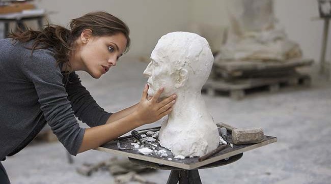 artist working on bust